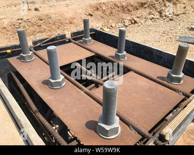 Reinforced concrete foundation with metal anchor bolts designed for the ...