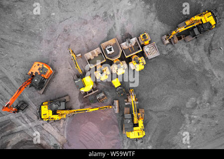 Construction site diggers yellow and orange aerial view from above Stock Photo