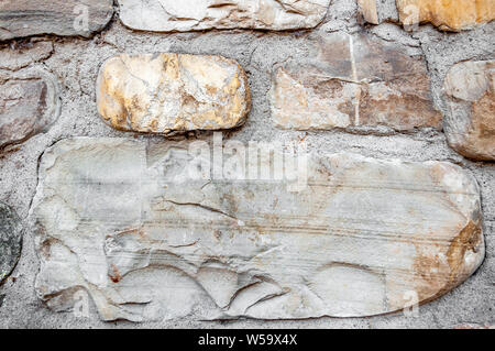 Typical wall of ancient Italian house made of hand-carved stones and bricks Stock Photo