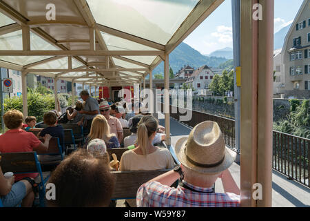 Arosa, GR / Switzerland - 24. July, 2019: tourists enjoy traveling in the open panorama carriage from Chur to Arosa Stock Photo