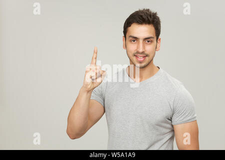 Portrait of a man pointing upward Stock Photo