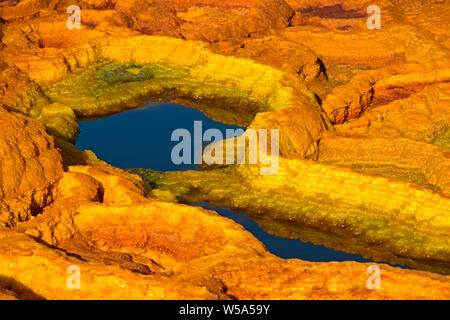 Rust-colored salt structures in an acid brine pool, geothermal field of Dallol, Danakil depression, Afar Triangle, Ethiopia Stock Photo