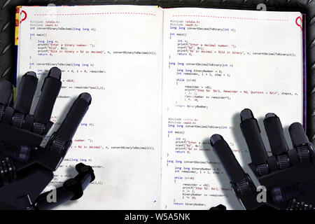 Machine learning placard. Robot reads textbook with binary code as illustration of artificial intelligence. Futuristic concept of digital knowledge ex Stock Photo