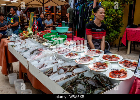 Fresh Seafood and Meat Dishes Displayed Outside A Beachfront Restaurant, Alona Beach, Bohol, The Philippines Stock Photo