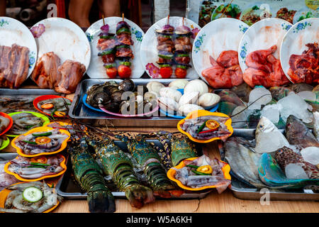 Fresh Seafood and Meat Dishes Displayed Outside A Beachfront Restaurant, Alona Beach, Bohol, The Philippines Stock Photo