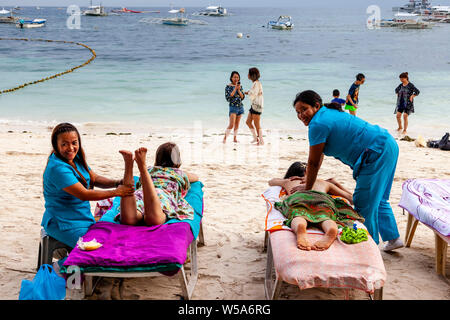 Tourists Having A Massage On Alona Beach, Bohol, The Philippines Stock