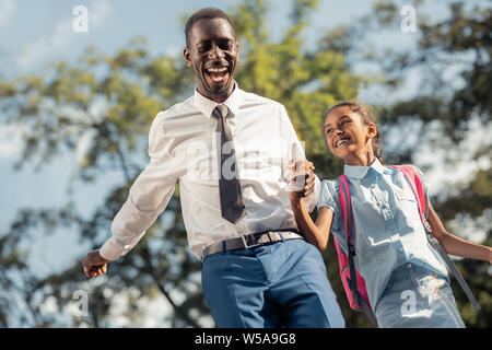 Amazing international girl having fun with her parent Stock Photo