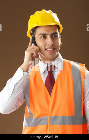 Male architect talking on mobile phone Stock Photo