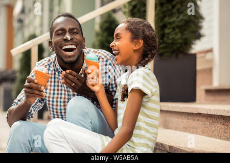 Amazing little female laughing at her daddy Stock Photo