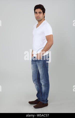 Man standing with his hands in pockets Stock Photo