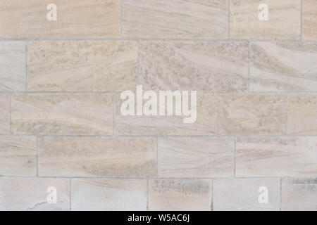 beige sandstone wall as background Stock Photo