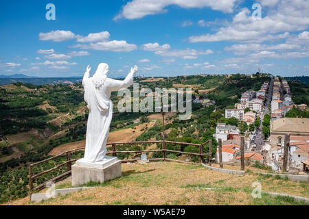 The statue of Christ the Redeemer over the town of Pomarico. Basilicata, Italy Stock Photo