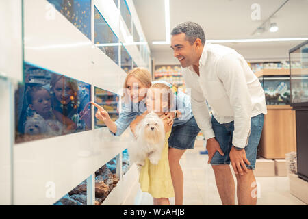 Loving parents taking their little girl to aquarium at the weekend Stock Photo