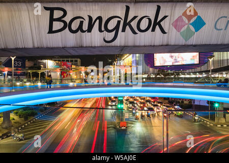 Bangkok, Thailand - March 3, 2019: Bangkok sign at the BTS metro bridge and busy street at night at downtown city center Stock Photo