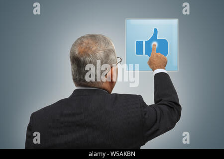 Rear view of a businessman using on touch screen Stock Photo