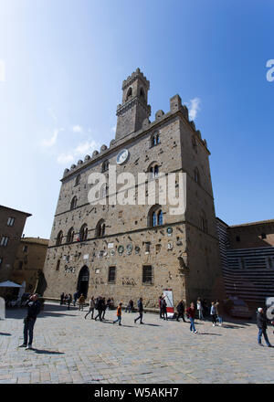 San Gimignano, Italy - April 11, 2015: historic building in san gimignano in tuscany, Italy. Tourists are walking around taking picture Stock Photo