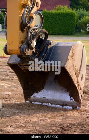 excavator bucket macro shot, dredger bucket close-up view of excavator on construction site Stock Photo