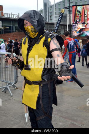 Attendees at the MCM Comic Con pop culture convention in Manchester, uk, July 27, 2019, at the start of a two day event where many participants dress up as their favourite superhero, anime, villain or pokemon character. The event attracts thousands of sci- fi enthusiasts, comic collectors, fantasy and game fans to the Manchester Central Convention Centre in city centre Manchester. Stock Photo