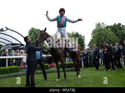 Frankie Dettori jumps from Enable after winning The King George VI & Queen Elizabeth QIPCO Stakes Race run during QIPCO King George Day at Ascot Racecourse. Stock Photo