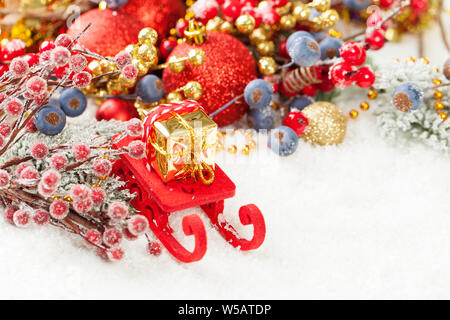 Christmas background with red Santa sleigh and Xmas gift on white snow with empty copy space Stock Photo