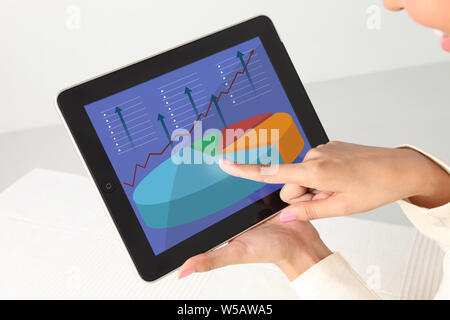 Businesswoman working on a digital tablet Stock Photo