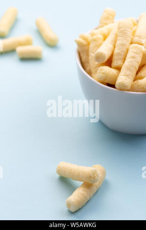 Crunchy corn puffs, pufuleti in white bowl Stock Photo