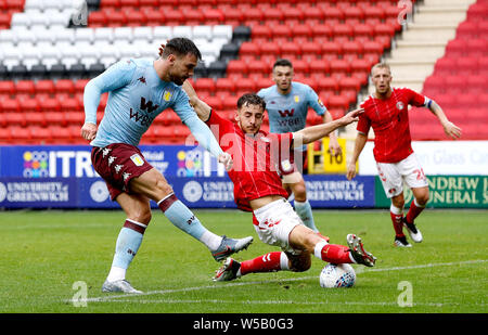 Aston Villa's Scott Hogan (left) shoots the ball past Charlton Athletic's Tom Lockyer during the pre-season friendly match at The Valley, London. Stock Photo