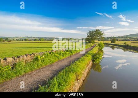 Landscape view of English rural countryside scenery on British waterway canal with blue sky Stock Photo