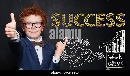 Smiling child with hand drawing sketch and success text. Business idea and success concept Stock Photo