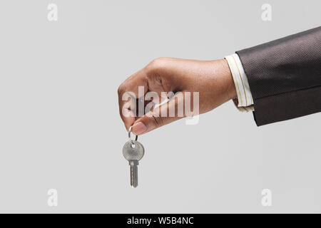 Businessman showing office key Stock Photo
