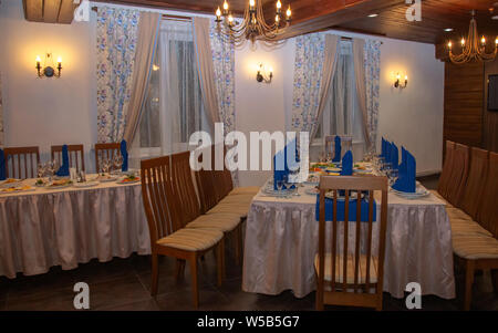 Photo background room with cloth covered tables and chairs for a festive banquet. Stock Photo