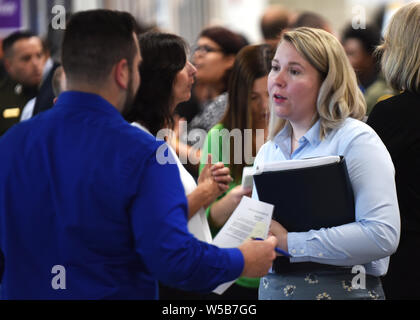 Orlando, United States. 26th July, 2019. July 26, 2019 - Orlando, Florida, United States - A woman speaks to a recruiter at the OrlandoJobs.com Job Fair at the Amway Center on July 26, 2016 in OrIando, Florida. Credit: Paul Hennessy/Alamy Live News Stock Photo