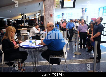 Orlando, United States. 26th July, 2019. July 26, 2019 - Orlando, Florida, United States - People have their resumes reviewed at the OrlandoJobs.com Job Fair at the Amway Center on July 26, 2016 in OrIando, Florida. Credit: Paul Hennessy/Alamy Live News Stock Photo