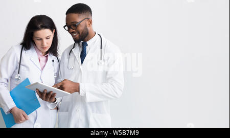 Two doctors in white coats discussing diagnosis Stock Photo