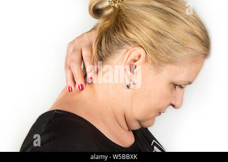 Mature women with neck pain. Self massage concept Stock Photo