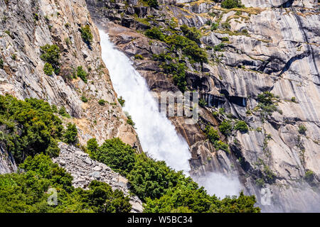 View towards Wapama falls dropping along granite walls; Hetch Hetchy Reservoir area, Yosemite National Park, Sierra Nevada mountains, California Stock Photo