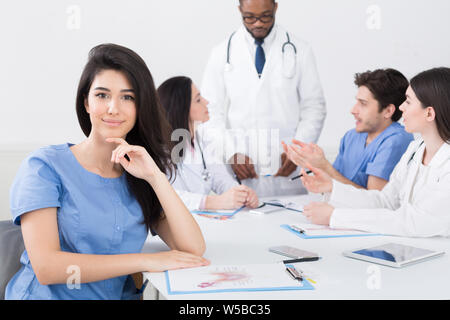 Meeting of medical staff. Nurse smiling to camera Stock Photo