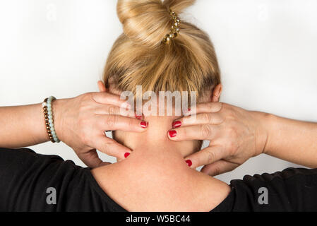 Mature women with neck pain. Self massage concept Stock Photo