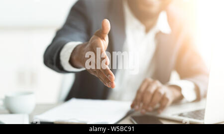 African businessman gives hand for handshake proposes partnership Stock Photo
