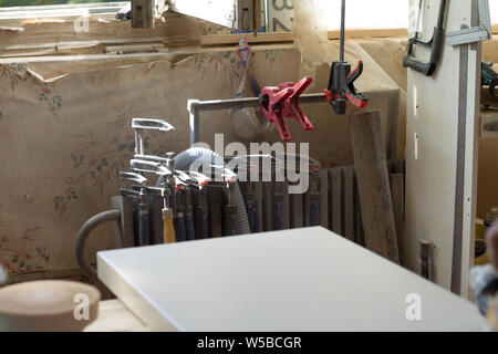 Many different joinery tools in a furniture workshop, selective focus Stock Photo