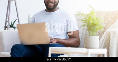 Black man typing text or programming code on laptop Stock Photo