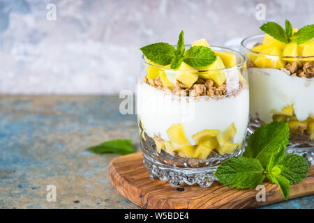 Parfait with yogurt, mango and granola. Stock Photo