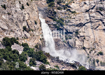 View towards Wapama falls dropping along granite walls; Hetch Hetchy Reservoir area, Yosemite National Park, Sierra Nevada mountains, California