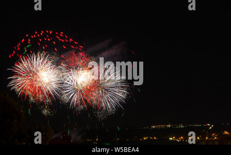Abstract colored firework against a black background with free space for text Stock Photo