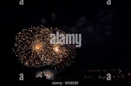 Abstract colored firework against a black background with free space for text Stock Photo