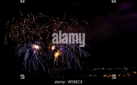 Abstract colored firework against a black background with free space for text Stock Photo
