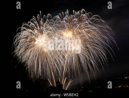 Abstract colored firework against a black background with free space for text Stock Photo