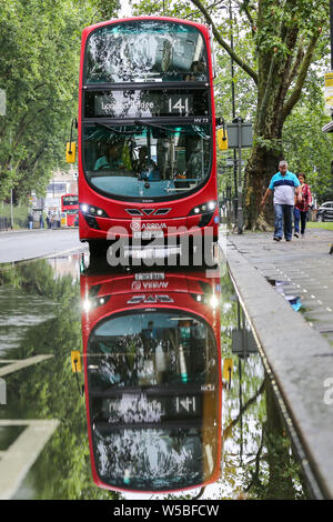 London, UK. 27th July, 2019. A reflection in a flood of water on Green Lanes in north London, caused by heavy overnight downpour. Credit: ZUMA Press, Inc./Alamy Live News Stock Photo