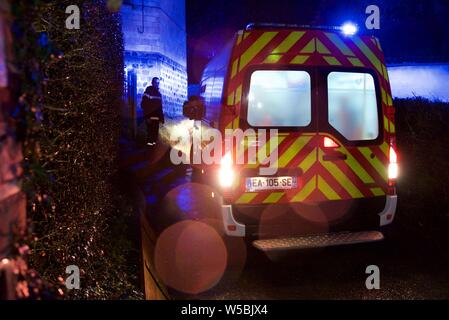 Hauts-de-France/France-March 10 2019: Pompier/paramedic ambulance attending an emergency call out on a rainy night in a rural location Stock Photo