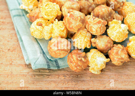 Caramelized popcorn on table Stock Photo